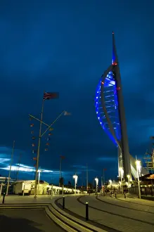 Port Prints: View of waterfront with Spinnaker Tower illuminated under stormclouds at dusk