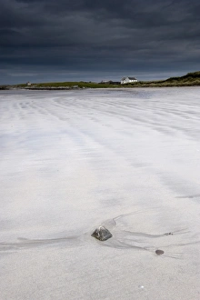 Sandy Prints: View of wave patterns on sandy beach and stormclouds