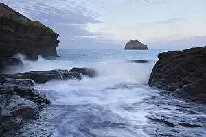 Wave Prints: View of waves crashing through manmade gully in coastal rocks at sunrise