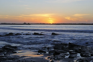 Sun Set Prints: View of waves and rocks on beach at sunset