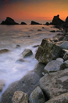 Wave Prints: View of waves on rocky beach at sunset, Mupe Bay, Lulworth Estate, Dorset, England, april