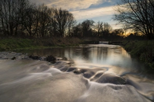 Evening Prints: View of weir on river tributary at sunset