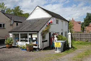 Elderly Prints: Village charity shop, Audlem, Cheshire, England, august