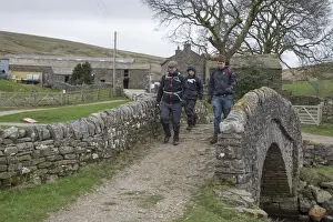 Footpath Prints: Walkers crossing bridge near farmyard on Coast to Coast Walk
