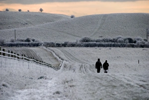 Sun Set Prints: Walkers on frost and snow covered footpath at sunset