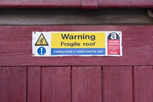 Signposts Prints: Warning, Fragile roof sign on farm building, Kirkby Stephen, Cumbria, England, March