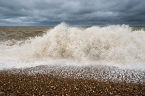 Waves crashing against shoreline of shingle beach, Dungeness, Kent, England, June