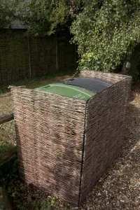 Trending: Willow enclosure used to screen wheelie bins in garden, England, september