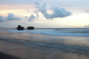 Wind blowing over waves on beach at sunset, Tanah Lot, Bali, Lesser Sunda Islands, Indonesia