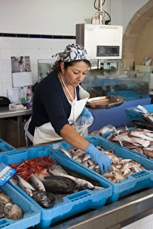 Woman Prints: Woman selling freshly landed fish on market stall