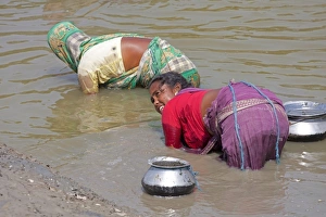 : Woman subsistence fishing by touch of hand