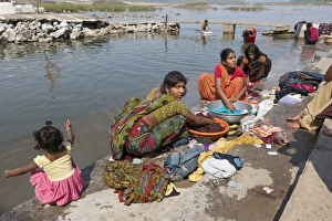 Subcontinent Prints: Women washing clothes in river, near Jabalpur, Madhya Pradesh, India, March