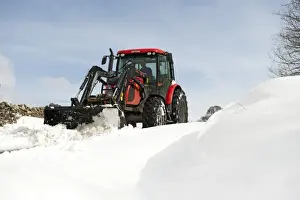 Blizzard Prints: Zetor tractor with loader clearing snow from blocked rural road after snowstorm